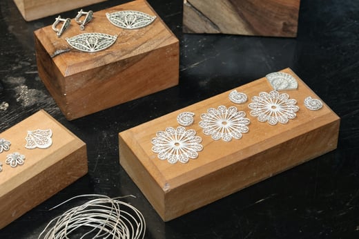 Photo by Tahir Xəlfə from Pexels: https://www.pexels.com/photo/intricate-silver-jewelry-on-wooden-blocks-33873052/